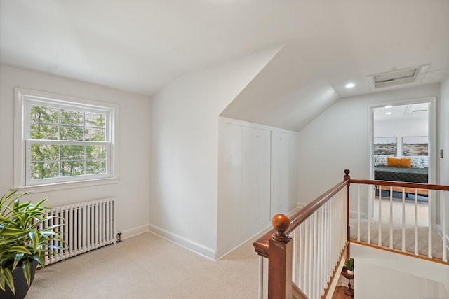 bonus room with vaulted ceiling, radiator heating unit, attic access, carpet, and baseboards