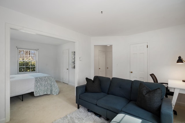 living room with baseboards and light colored carpet