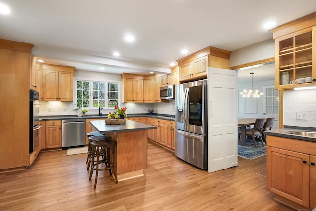 kitchen with tasteful backsplash, dark countertops, recessed lighting, light wood-style floors, and appliances with stainless steel finishes