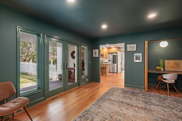 entryway featuring recessed lighting, light wood finished floors, visible vents, french doors, and baseboards