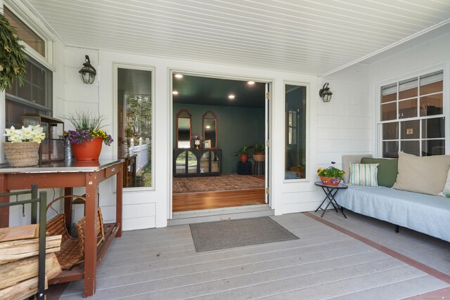 view of exterior entry with a deck