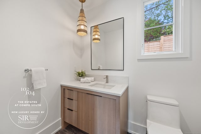 102 Compo Rd S, Westport, CT 06880 - bathroom with toilet, baseboards, and vanity