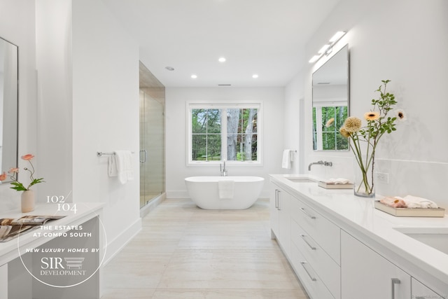 102 Compo Rd S, Westport, CT 06880 - bathroom featuring double vanity, a stall shower, a sink, a freestanding tub, and recessed lighting