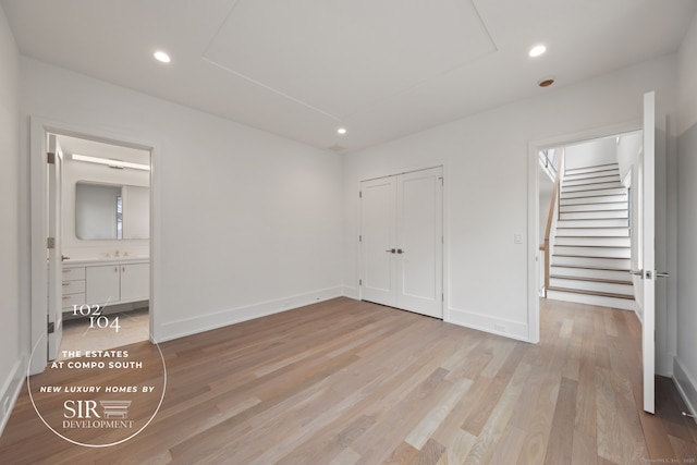 102 Compo Rd S, Westport, CT 06880 - unfurnished bedroom with baseboards, recessed lighting, connected bathroom, and light wood-type flooring