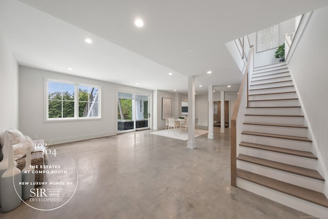 102 Compo Rd S, Westport, CT 06880 - unfurnished living room with baseboards, stairs, recessed lighting, and concrete floors