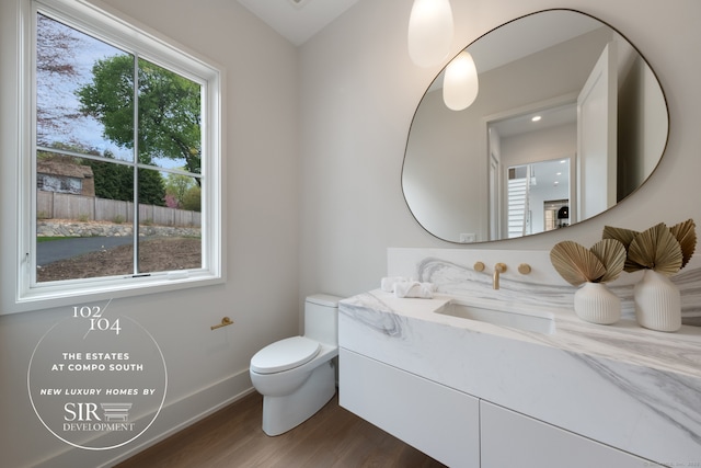 102 Compo Rd S, Westport, CT 06880 - half bath featuring toilet, baseboards, wood finished floors, and vanity