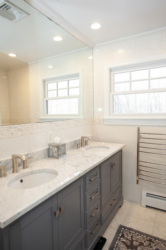 18 Cardinal Rd, Weston, CT 06883 - bathroom with baseboard heating, tile walls, double vanity, and marble look tile flooring