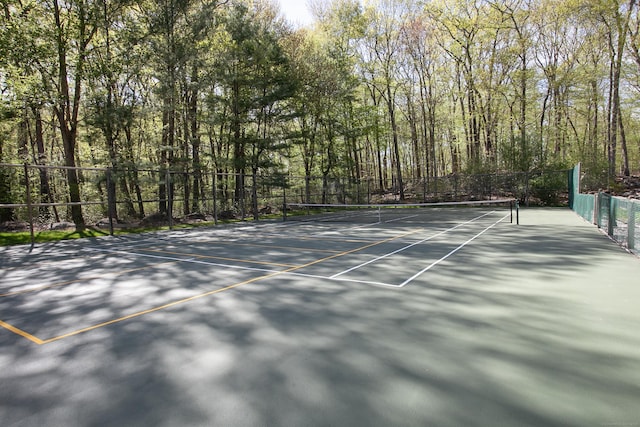 18 Cardinal Rd, Weston, CT 06883 - view of tennis court featuring a wooded view