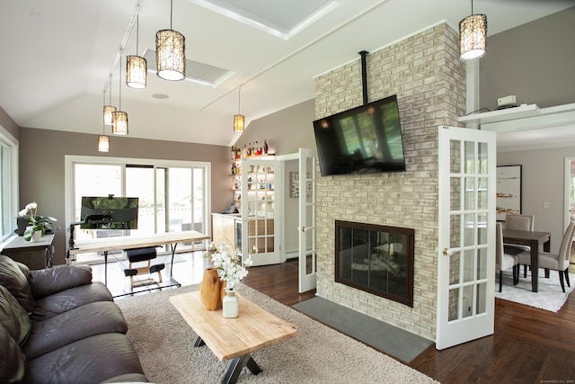18 Cardinal Rd, Weston, CT 06883 - living room with wood finished floors, lofted ceiling, healthy amount of natural light, and a brick fireplace
