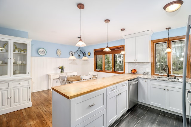 594 Barrack Hill Rd, Ridgefield, CT 06877 - kitchen with butcher block counters, a sink, a peninsula, dishwasher, and white cabinets