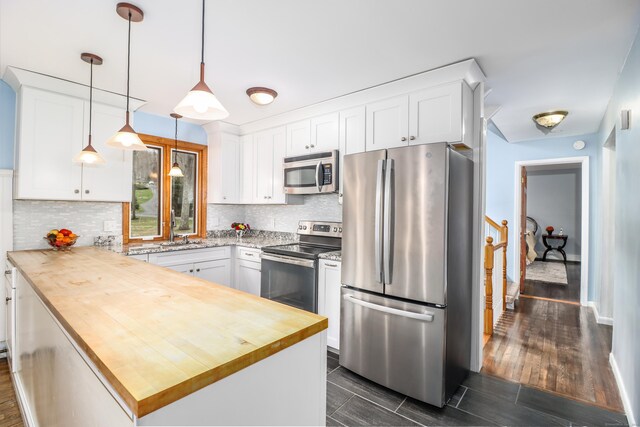 594 Barrack Hill Rd, Ridgefield, CT 06877 - kitchen with appliances with stainless steel finishes, butcher block countertops, decorative backsplash, and white cabinetry