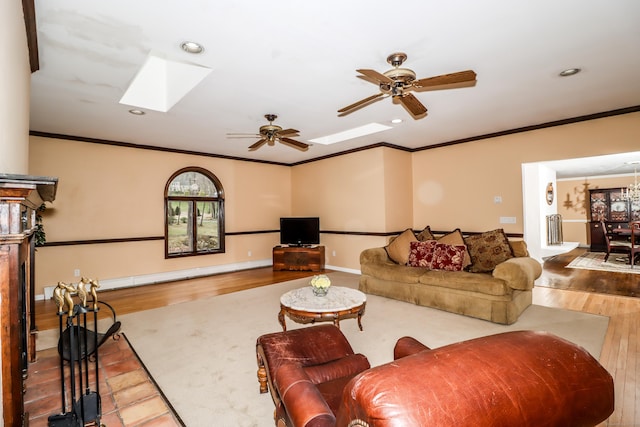 594 Barrack Hill Rd, Ridgefield, CT 06877 - living area with a skylight, wood finished floors, a ceiling fan, recessed lighting, and ornamental molding