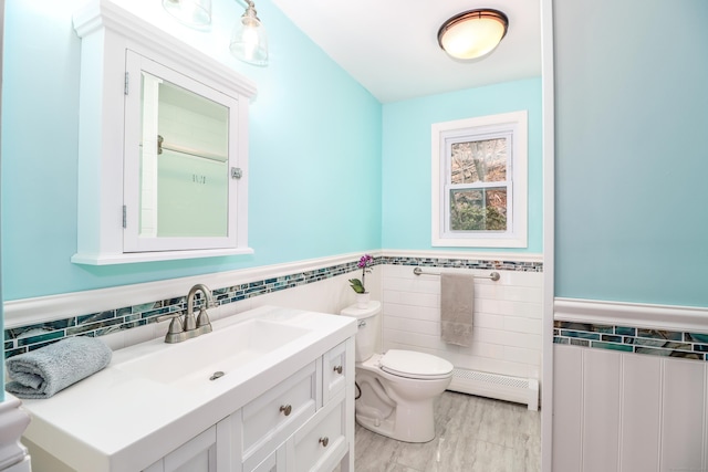 594 Barrack Hill Rd, Ridgefield, CT 06877 - bathroom featuring tile walls, baseboard heating, toilet, a wainscoted wall, and vanity
