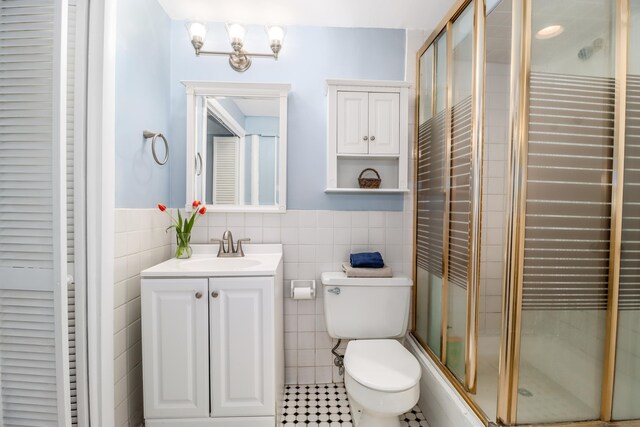 594 Barrack Hill Rd, Ridgefield, CT 06877 - full bath with tile walls, a shower with shower door, toilet, tile patterned flooring, and vanity