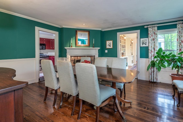 341 Housatonic River Rd, Salisbury, CT 06068 - dining space with wainscoting, hardwood / wood-style flooring, ornamental molding, and a fireplace