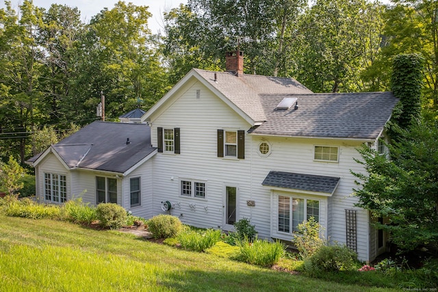 341 Housatonic River Rd, Salisbury, CT 06068 - back of property featuring a chimney, a shingled roof, and view of scattered trees