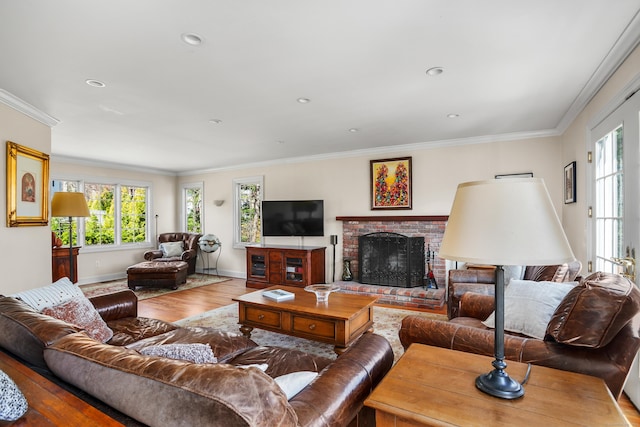 living area with baseboards, a brick fireplace, crown molding, and wood finished floors
