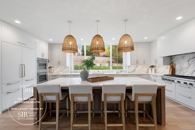 104 Compo Rd S, Westport, CT 06880 - kitchen featuring a sink, a breakfast bar area, backsplash, a kitchen island, and appliances with stainless steel finishes