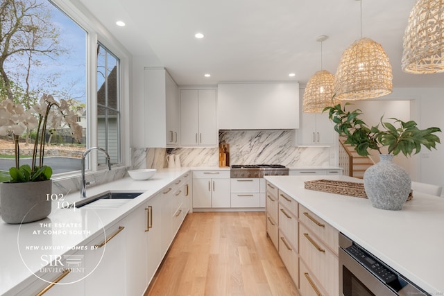 104 Compo Rd S, Westport, CT 06880 - kitchen featuring a sink, light wood finished floors, light countertops, and appliances with stainless steel finishes