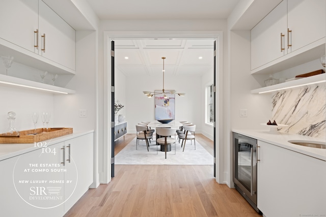 104 Compo Rd S, Westport, CT 06880 - bar with light wood finished floors, beverage cooler, coffered ceiling, and indoor wet bar