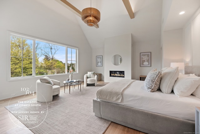 104 Compo Rd S, Westport, CT 06880 - bedroom with light wood-style flooring, beamed ceiling, high vaulted ceiling, and a glass covered fireplace