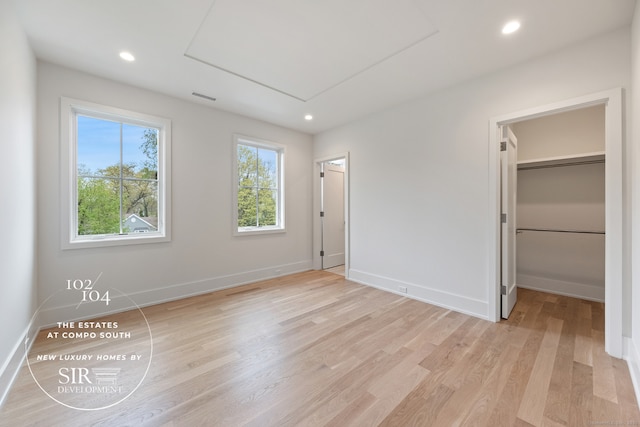 104 Compo Rd S, Westport, CT 06880 - unfurnished bedroom featuring baseboards, light wood-style floors, visible vents, and a walk in closet