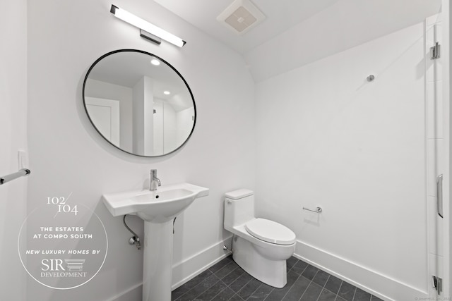 104 Compo Rd S, Westport, CT 06880 - bathroom with toilet, visible vents, vaulted ceiling, tile patterned flooring, and baseboards