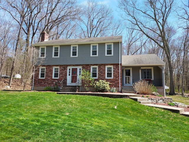 43 Attawanhood Trl, Hebron, CT 06231 - colonial inspired home featuring a chimney, brick siding, a porch, and a front yard