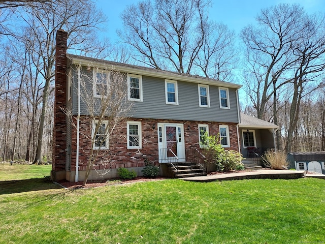 43 Attawanhood Trl, Hebron, CT 06231 - colonial inspired home featuring a chimney, brick siding, and a front yard
