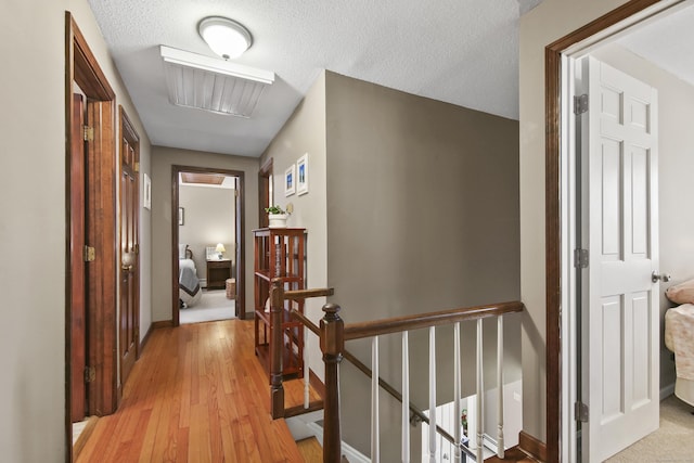 43 Attawanhood Trl, Hebron, CT 06231 - corridor featuring baseboards, light wood-type flooring, and an upstairs landing
