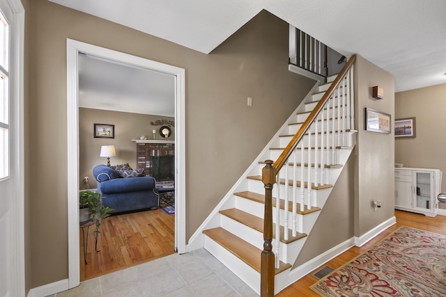 43 Attawanhood Trl, Hebron, CT 06231 - staircase featuring baseboards, wood finished floors, and a fireplace