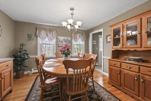43 Attawanhood Trl, Hebron, CT 06231 - dining area featuring an inviting chandelier, a baseboard radiator, light wood-type flooring, and baseboards