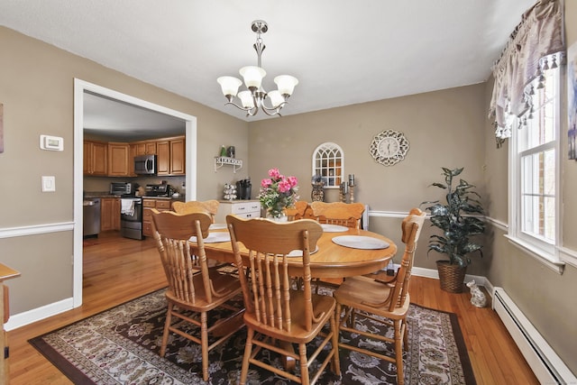 43 Attawanhood Trl, Hebron, CT 06231 - dining area with baseboards, a notable chandelier, a baseboard heating unit, and light wood-style floors