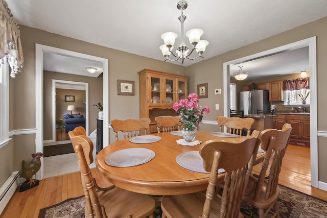 43 Attawanhood Trl, Hebron, CT 06231 - dining room featuring baseboard heating, an inviting chandelier, and light wood-style floors