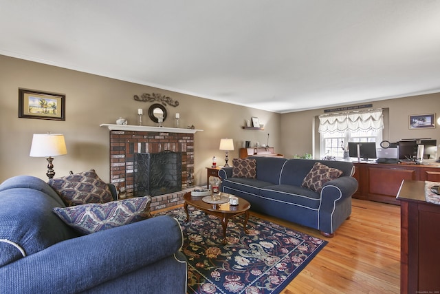 43 Attawanhood Trl, Hebron, CT 06231 - living area with a fireplace, crown molding, and light wood finished floors