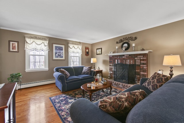 43 Attawanhood Trl, Hebron, CT 06231 - living area with ornamental molding, a baseboard heating unit, wood finished floors, and a fireplace