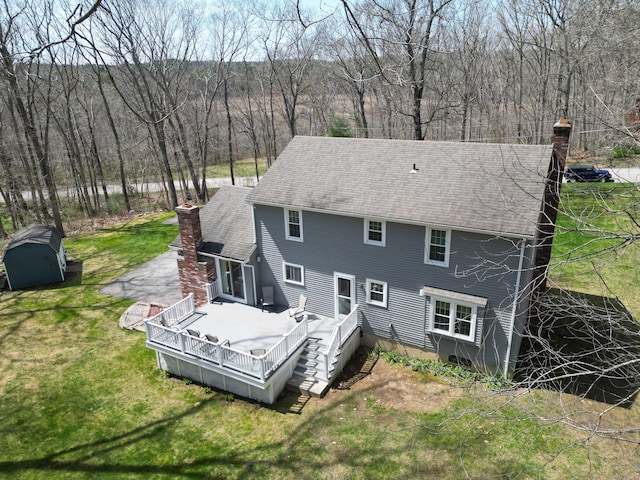 43 Attawanhood Trl, Hebron, CT 06231 - back of house with a lawn, a chimney, a storage shed, and a deck