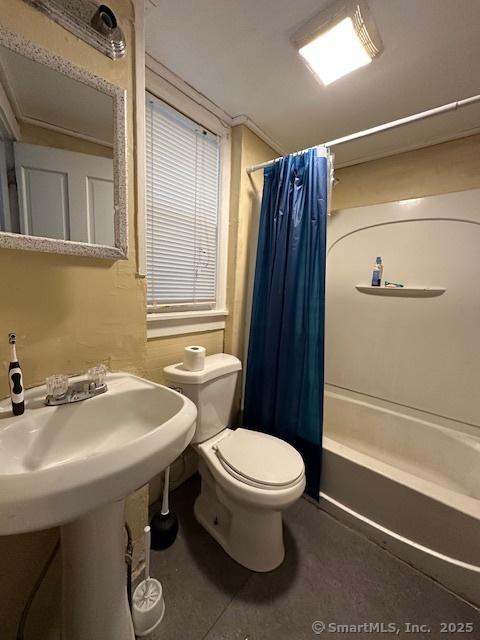 bathroom with toilet and shower / bathtub combination with curtain