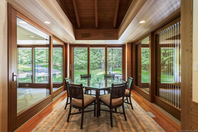 sunroom with wooden ceiling, a healthy amount of sunlight, and wood-type flooring