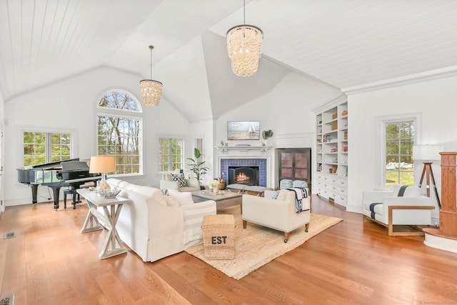47 Peaceable St, Ridgefield, CT 06877 - living room featuring a chandelier, light wood-type flooring, a fireplace, and high vaulted ceiling