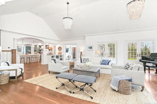 47 Peaceable St, Ridgefield, CT 06877 - living area with decorative columns, arched walkways, a chandelier, wood finished floors, and high vaulted ceiling