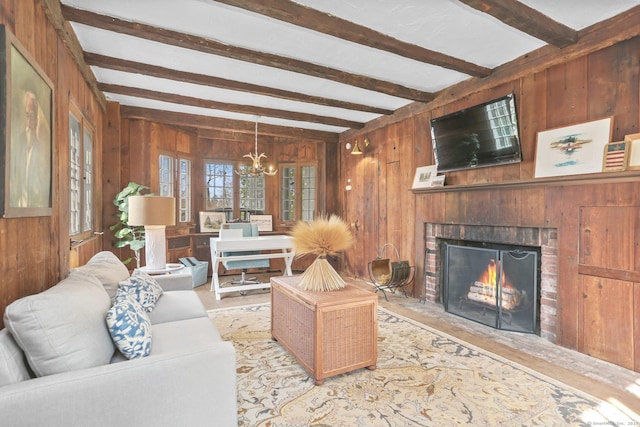 47 Peaceable St, Ridgefield, CT 06877 - living room featuring wood walls, a chandelier, beam ceiling, a fireplace, and wood finished floors