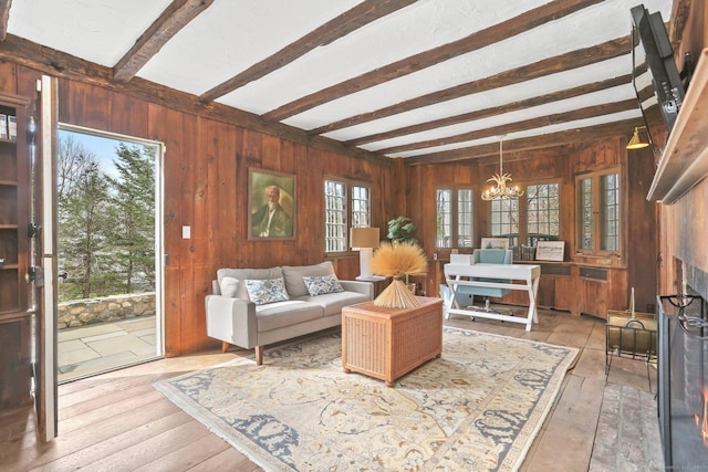 47 Peaceable St, Ridgefield, CT 06877 - living room featuring wood walls, a chandelier, beamed ceiling, and wood-type flooring