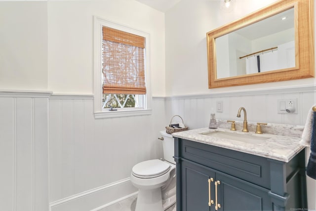 47 Peaceable St, Ridgefield, CT 06877 - bathroom featuring vanity, wainscoting, and toilet