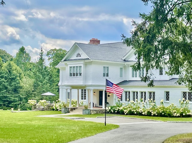 47 Peaceable St, Ridgefield, CT 06877 - view of front of home with a chimney, a front yard, roof with shingles, and a porch