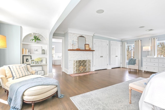 47 Peaceable St, Ridgefield, CT 06877 - living area featuring ornamental molding, wood finished floors, a brick fireplace, and built in shelves