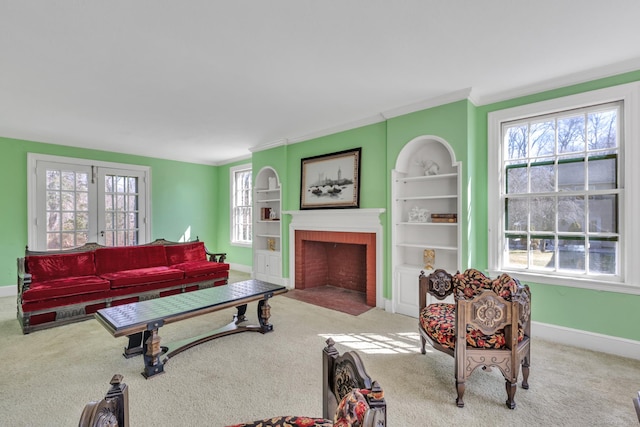 living room featuring baseboards, ornamental molding, and carpet