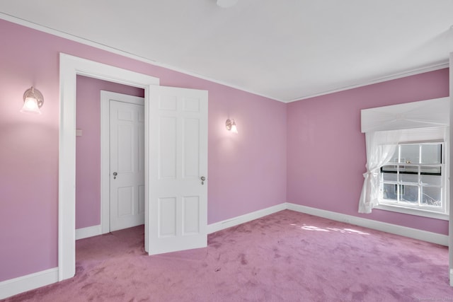 unfurnished bedroom featuring carpet floors and baseboards