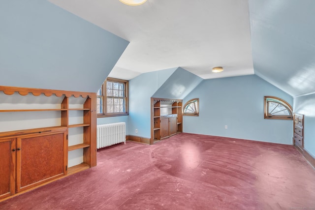 bonus room featuring radiator heating unit, vaulted ceiling, and carpet floors