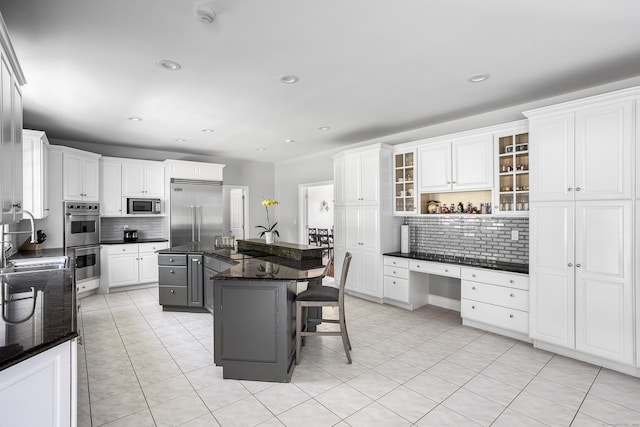 21 Centennial Dr, Danbury, CT 06811 - kitchen with a breakfast bar area, tasteful backsplash, a sink, stainless steel appliances, and white cabinetry